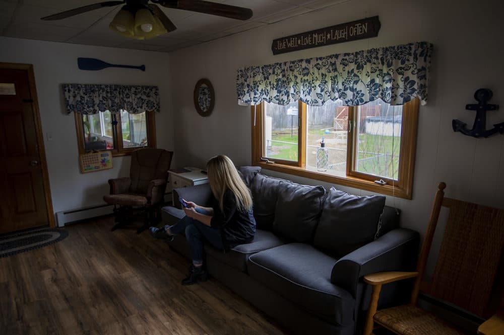 A woman whose last name is Smith, seen here in a family member's Massachusetts home, says she was sexually assaulted by a guard for Prisoner Transportation Services while being returned to the state for a probation violation. (Jesse Costa/WBUR)