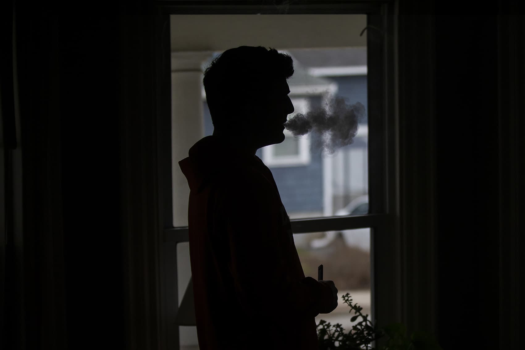 Victor uses a JUUL vaping device at home. (Jesse Costa/WBUR)