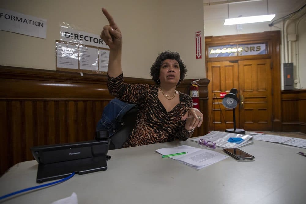 Joi Simmons directs a patron to where he needs to go in Brockton City Hall. (Jesse Costa/WBUR)