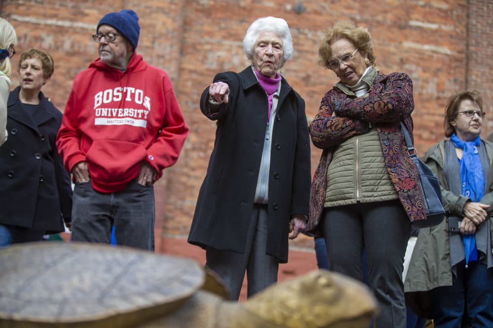 Sculptor Nancy Schön points out some of the details of her new bronze sculpture. (Jesse Costa/WBUR)