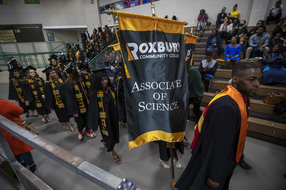 A procession of Roxbury Community College student enter the Reggie Lewis Arena. (Jesse Costa/WBUR)