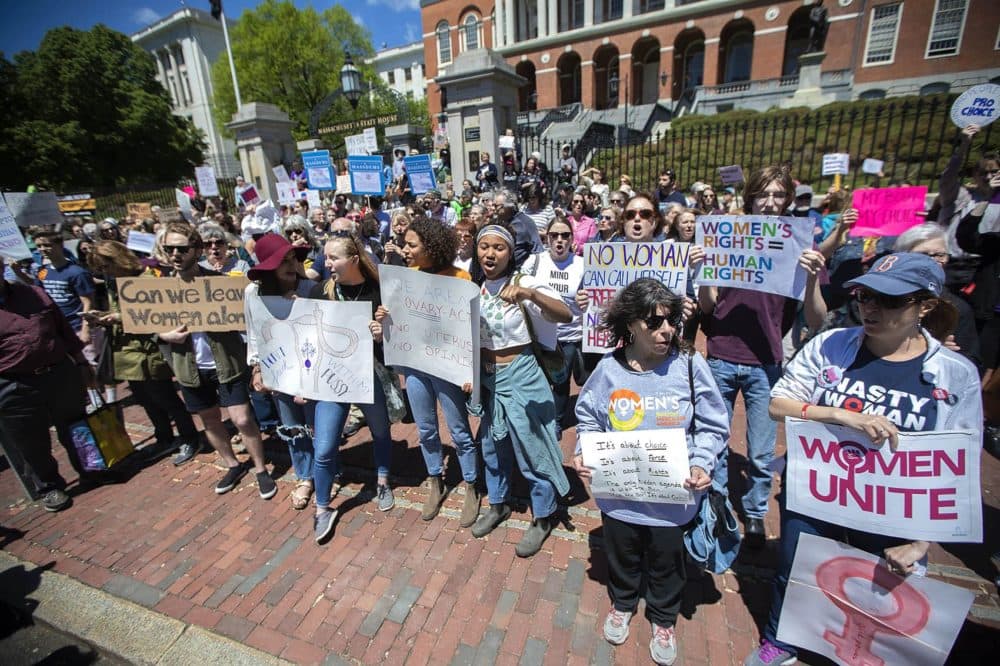 Protesters gathered in front of the Massachusetts State House for the #StopTheBans rally. (Jesse Costa/WBUR)