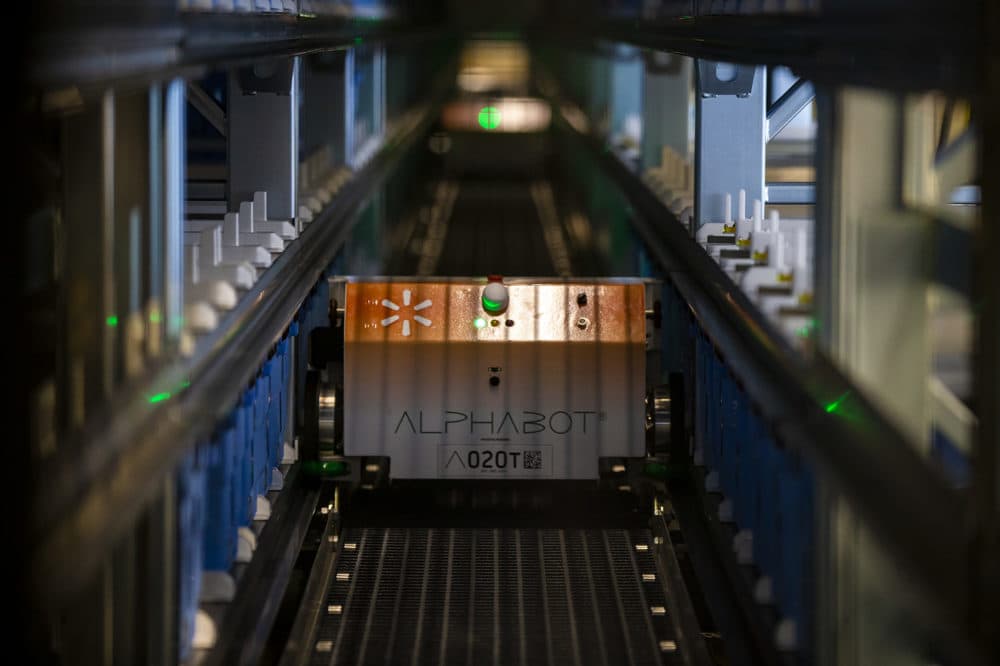 Walmart's Alphabot retrieves grocery items from a 20,000-square-foot warehouse, which it moves from storage to associates who fill online purchases at the Walmart Supercenter in Salem, New Hampshire. (Jesse Costa/WBUR)