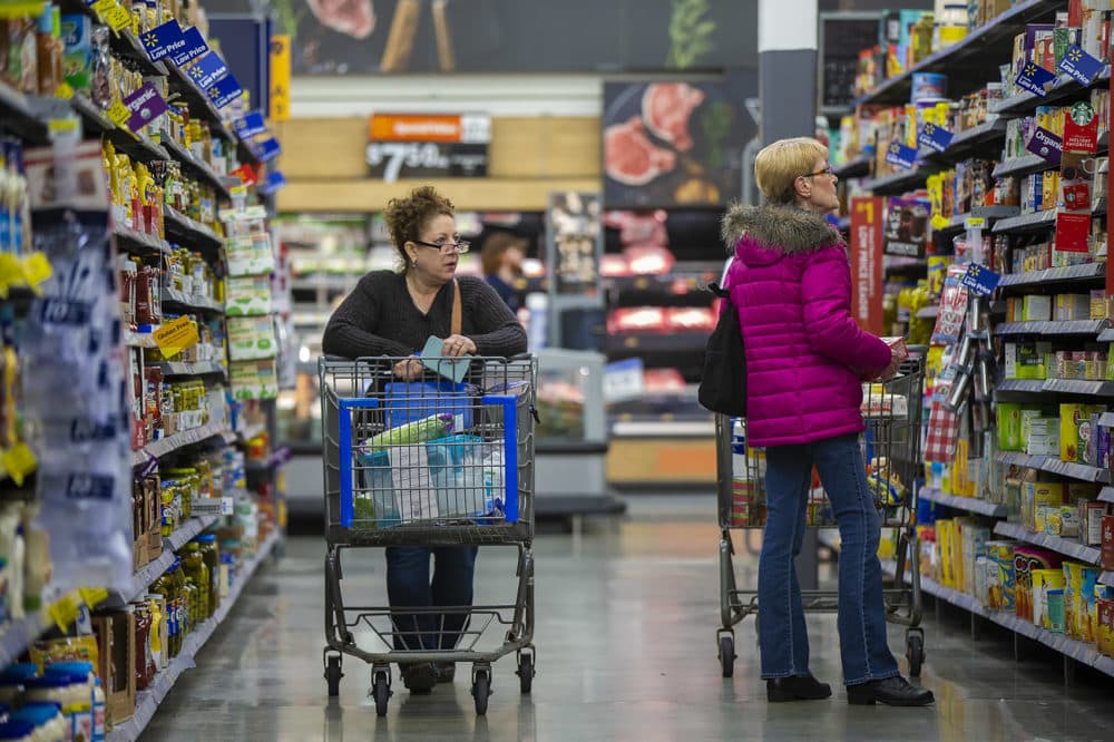 Customers peruse the aisles at the Walmart supercenter in Salem, New Hampshire. (Jesse Costa/WBUR)
