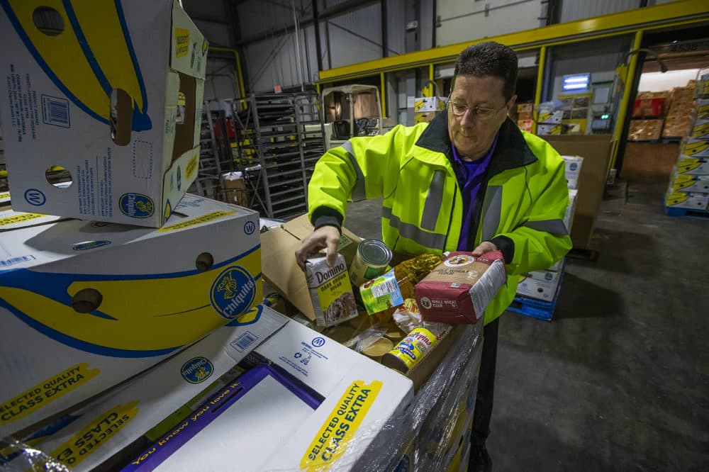 Roger Beliveau, Stop & Shop's manager of distribution services, shows some of the items being sent to the Greater Boston Food Bank. (Jesse Costa/WBUR)