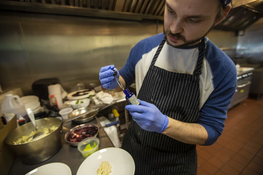 Chef David Ferragamo measuring a dose of CBD oil. (Jesse Costa/WBUR)