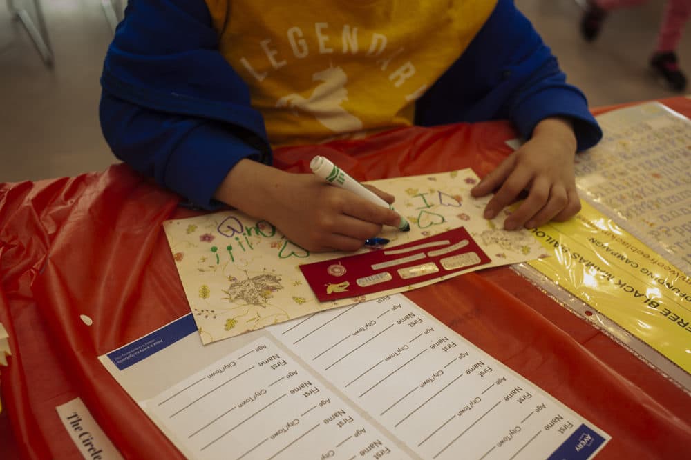 At the &quot;Wee Free Black Mamas&quot; event, children learn about racism and mass incarceration while making Mothers Day cards for incarcerated women (OJ Slaughter for WBUR)