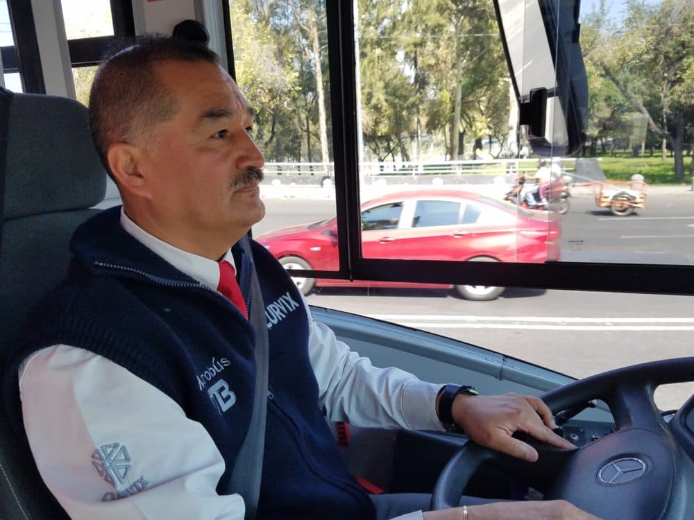 Jorge Mares has been a Metrobús driver for almost two years. The bus rapid transit system has its own dedicated lanes, which means Mares doesn't have to sit in traffic when he drives. (Zeninjor Enwemeka/WBUR)