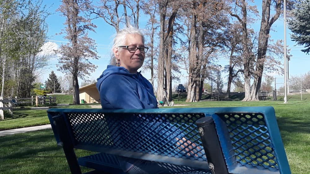 Leigh Ann Harris sits on a park bench in Washington. (Eilís O'Neal for WBUR)