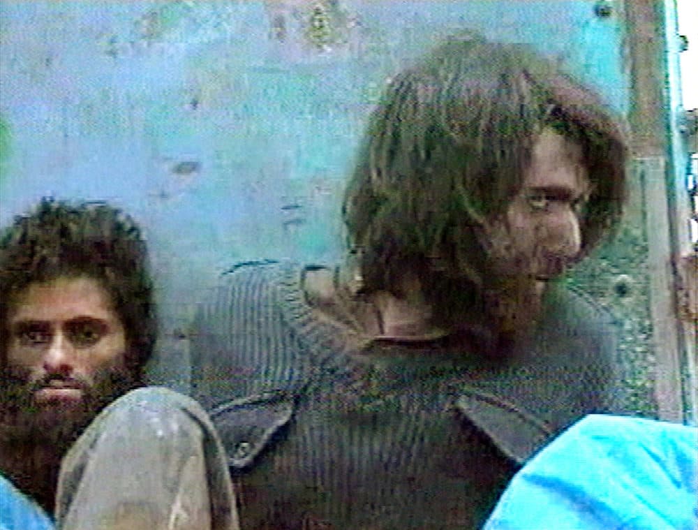 This image from television footage made in Mazar-i-Sharif, Afghanistan in 2001 shows John Walker Lindh at right, claiming to be an American Taliban volunteer calling himself Abdul Hamid. (AP Photo/APTN)