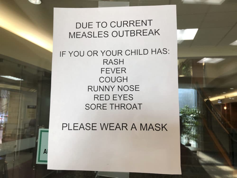 Signs posted at The Vancouver Clinic in Vancouver, Wash., warn patients and visitors of a measles outbreak on Wednesday, Jan. 30, 2019.(AP Photo/Gillian Flaccus)