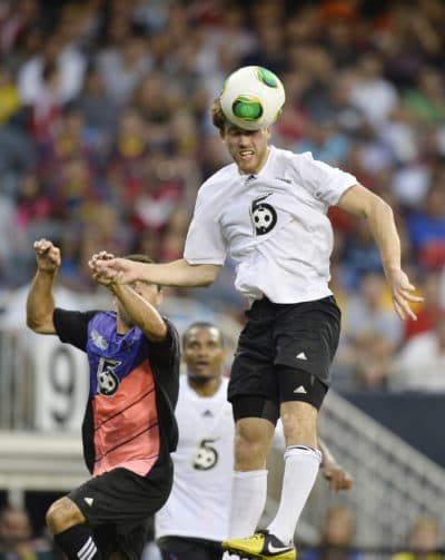 Matt Eliason goes up for a header against Messi. (Brian Kersey/AP)