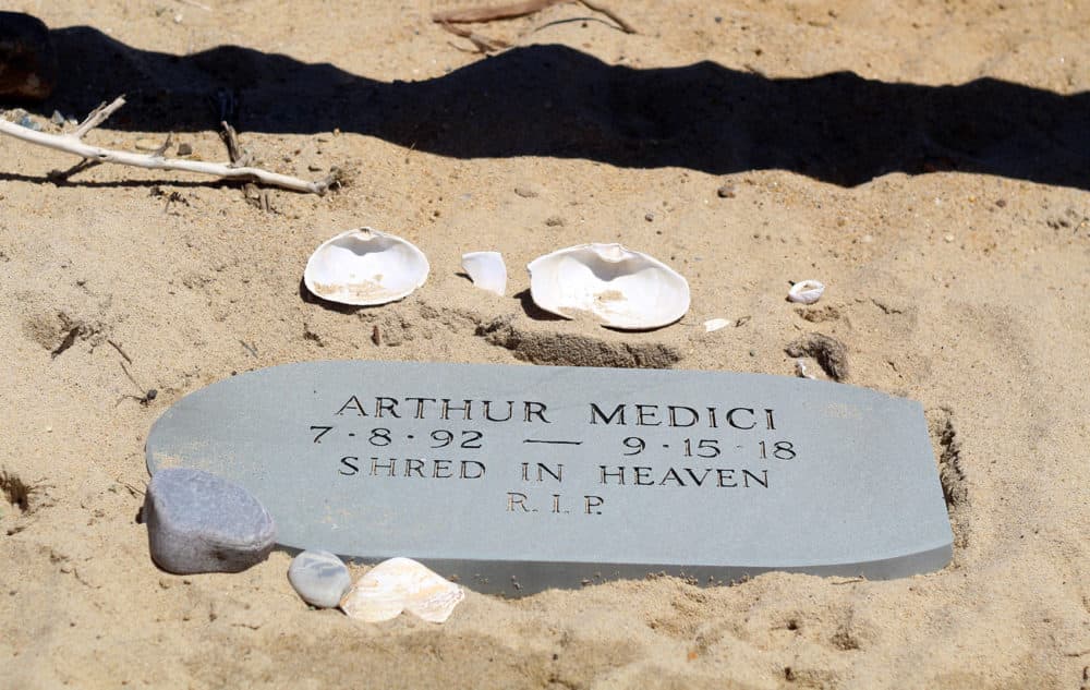 A memorial for Arthur Medici lays at the beach entrance. (Quincy Walters/WBUR)