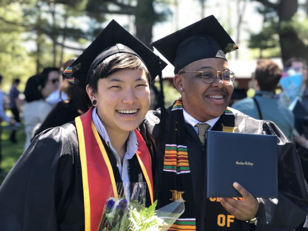 New Gordon College graduate Shinae Lee, left, poses for a photo with a classmate. (Max Larkin/WBUR)