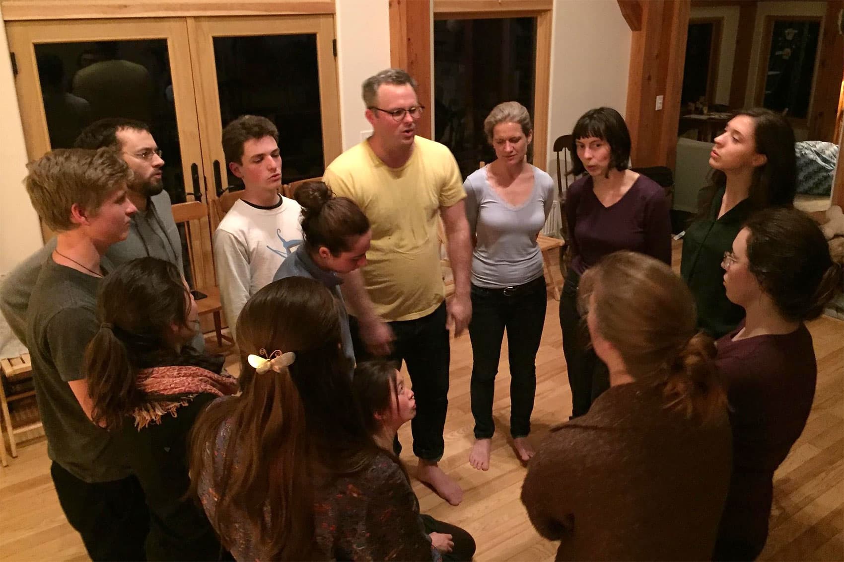 Bennett Konesni, in yellow, leads a chantey in Northport. (Ari Snider for Maine Public)