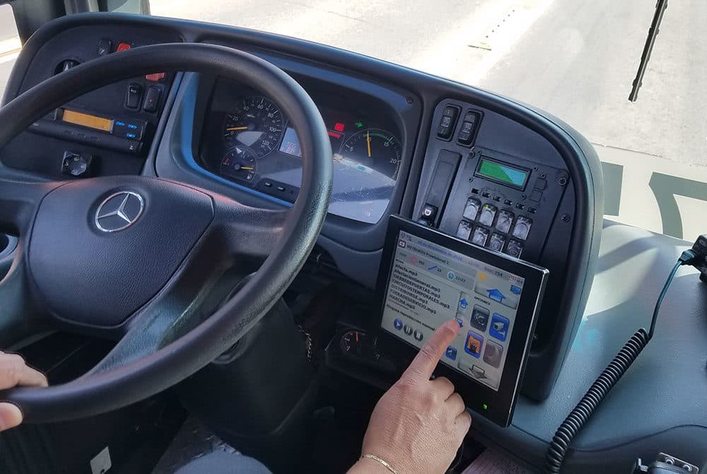 Metrobús driver Jorge Mares pushes a button on his screen to play a prerecorded announcement to his passengers. (Zeninjor Enwemeka/WBUR)