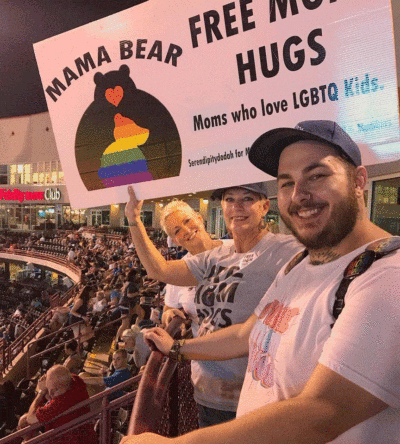 Sara Cunningham (center) with her son Parker Cunningham. Sara is holding a sign for her LGBTQ moms' organization (Courtesy Parker Cunningham)
