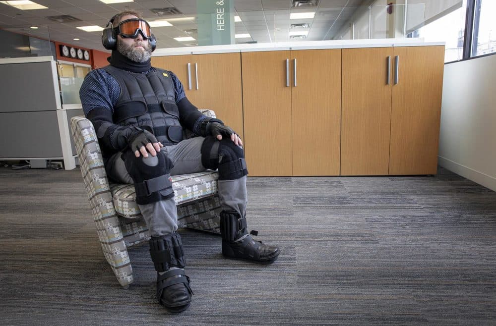 Corgan’s Mike Steiner sits in the age suit, which both weighs you down and limits your mobility and sensitivity to the world around you. (Robin Lubbock/WBUR)