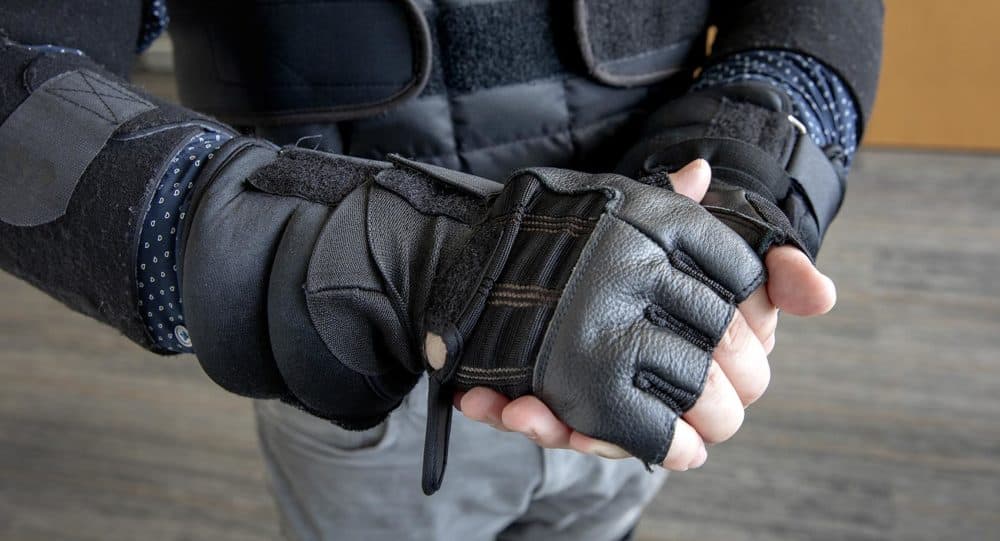 The age suit’s wrist weights and gloves limit mobility and sensitivity in your arms and hands. (Robin Lubbock/WBUR)
