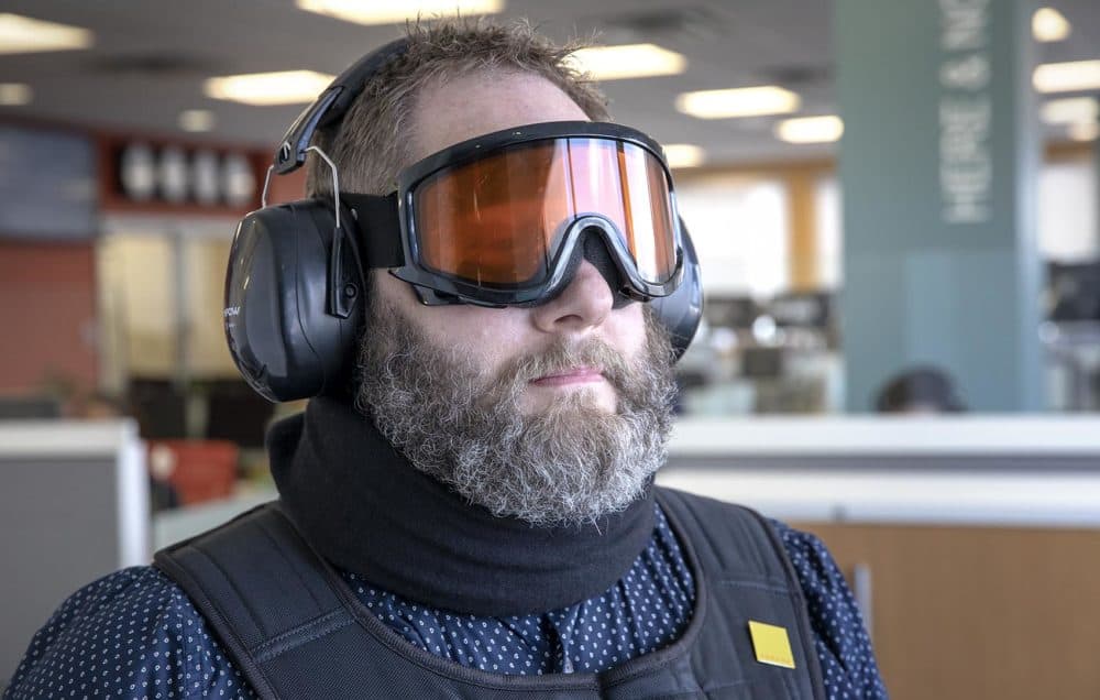 The age suit’s goggles, ear muffs, neck brace and weighted jacket limit the wearer’s freedom of movement and ability to sense the world. (Robin Lubbock/WBUR)