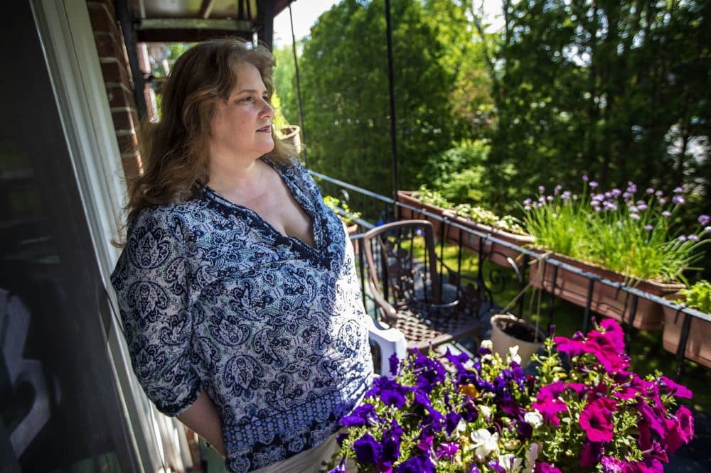 Diana Mamouni on the balcony of her condominium in North Andover. (Jesse Costa/WBUR)