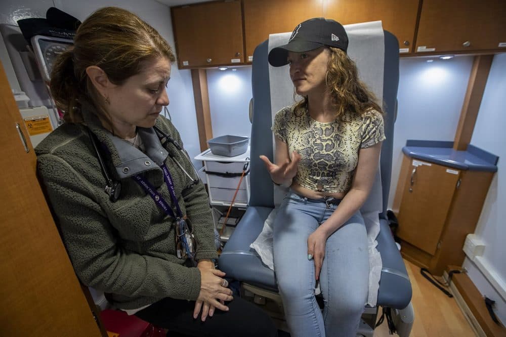 Dr. Jesse Gaeta consults with Bri about her health conditions during a checkup in the mini-exam room on the Care Zone van. (Jesse Costa/WBUR)