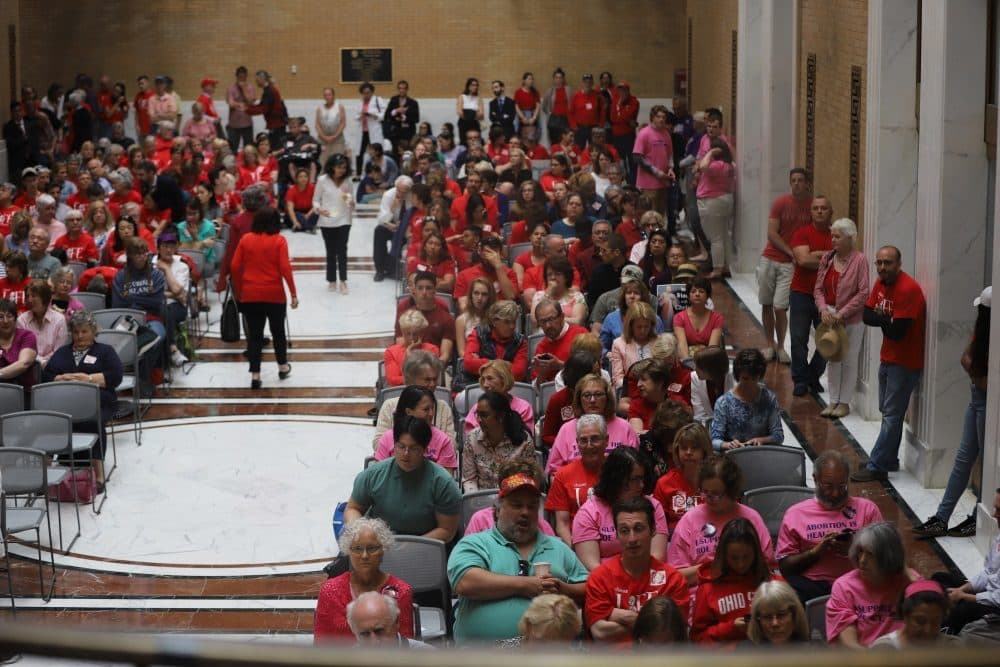 Activists crowded an overflow seating space in the Great Hall to watch a livestream of the Judiciary Committee's hearing on the abortion access bill. Testimony was being presented in the Gardner Auditorium, which quickly filled to capacity. (Sam Doran/SHNS)