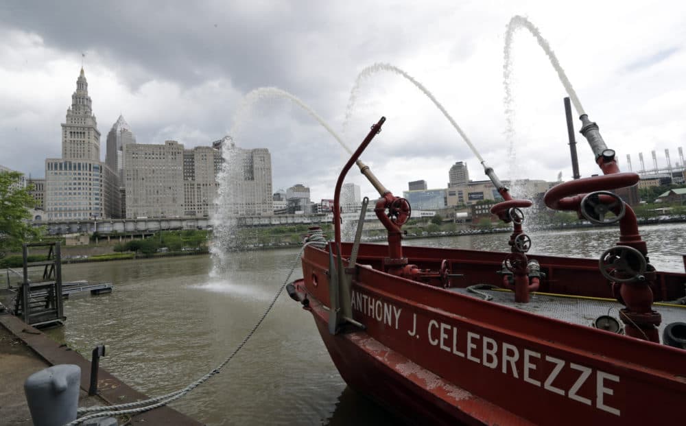 The Anthony J. Celebrezze rests near Fire Station 21 on the Cuyahoga River, Thursday, June 13, 2019, in Cleveland. Fire Station 21 battles the fires on the Cuyahoga River. The Celebrezze extinguished hot spots on a railroad bridge torched by burning fluids and debris on the Cuyahoga in 1969. (Tony Dejak/AP)