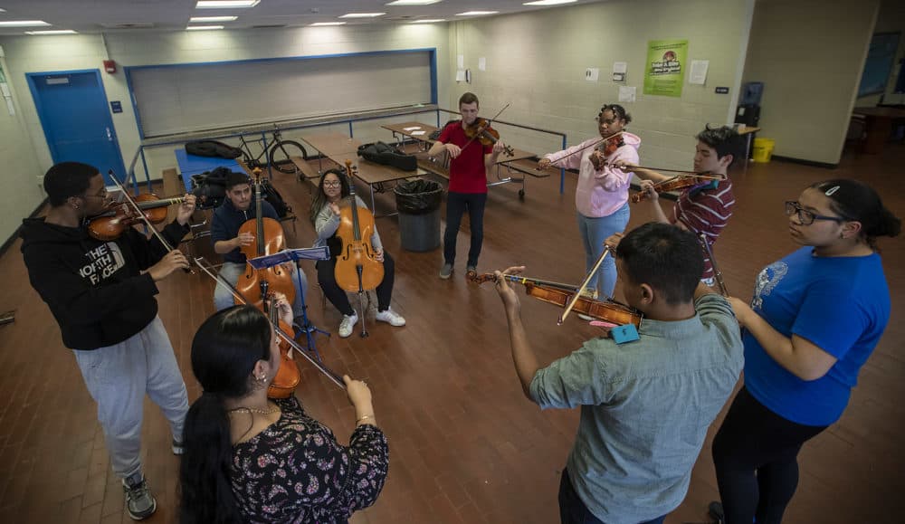 David France with members of his Roxbury Youth Orchestra (Jesse Costa/WBUR)