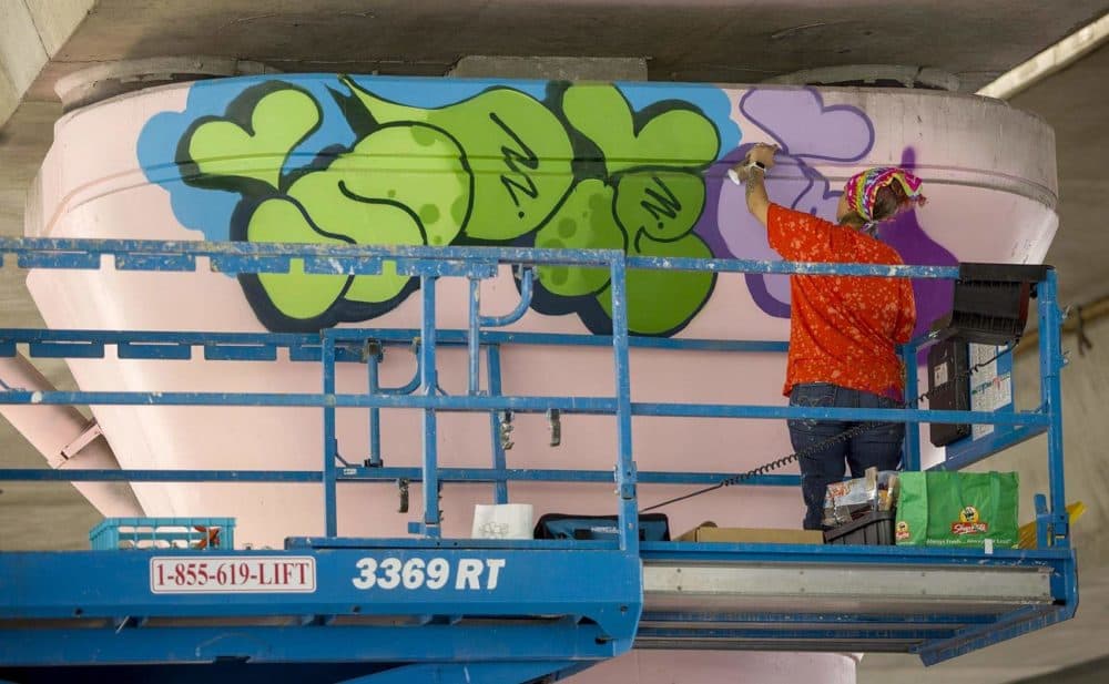 Artist Indie184 working on her mural at Underground at Ink Block. (Robin Lubbock/WBUR)