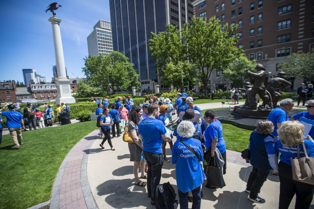 At a rally outside the State House on June 12, members of a coalition share stories of people who struggle to pay for their medicine. (Jesse Costa/WBUR)