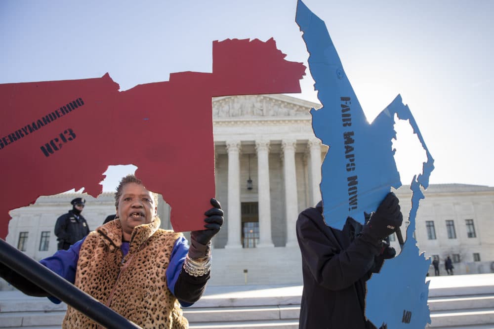 Activists at the Supreme Court opposed to partisan gerrymandering hold up representations of congressional districts from North Carolina, left, and Maryland, right, as justices hear arguments about the practice in Washington, Tuesday, March 26, 2019. (Carolyn Kaster/AP)