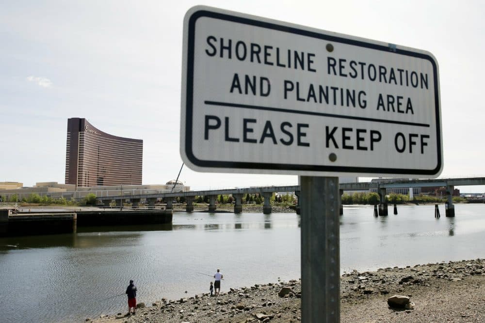 People fish in the Mystic River in Somerville, Mass., across from the Encore Boston Harbor, Wednesday, May 22, 2019. (Michael Dwyer/AP File Photo)