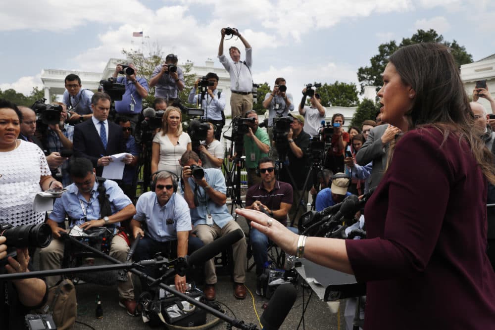 White House Press Secretary Sarah Sanders, right, answers questions from members of the media outside the White House on May 29. (Jacquelyn Martin/AP)