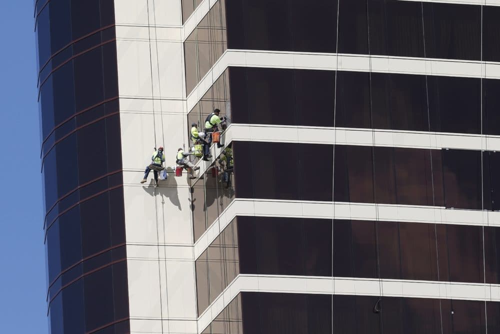 Window washers work on Encore Boston Harbor in Everett, Mass. On Thursday, June 6, the Labor Department issues revised data on productivity in the first quarter. (Michael Dwyer/AP File Photo)