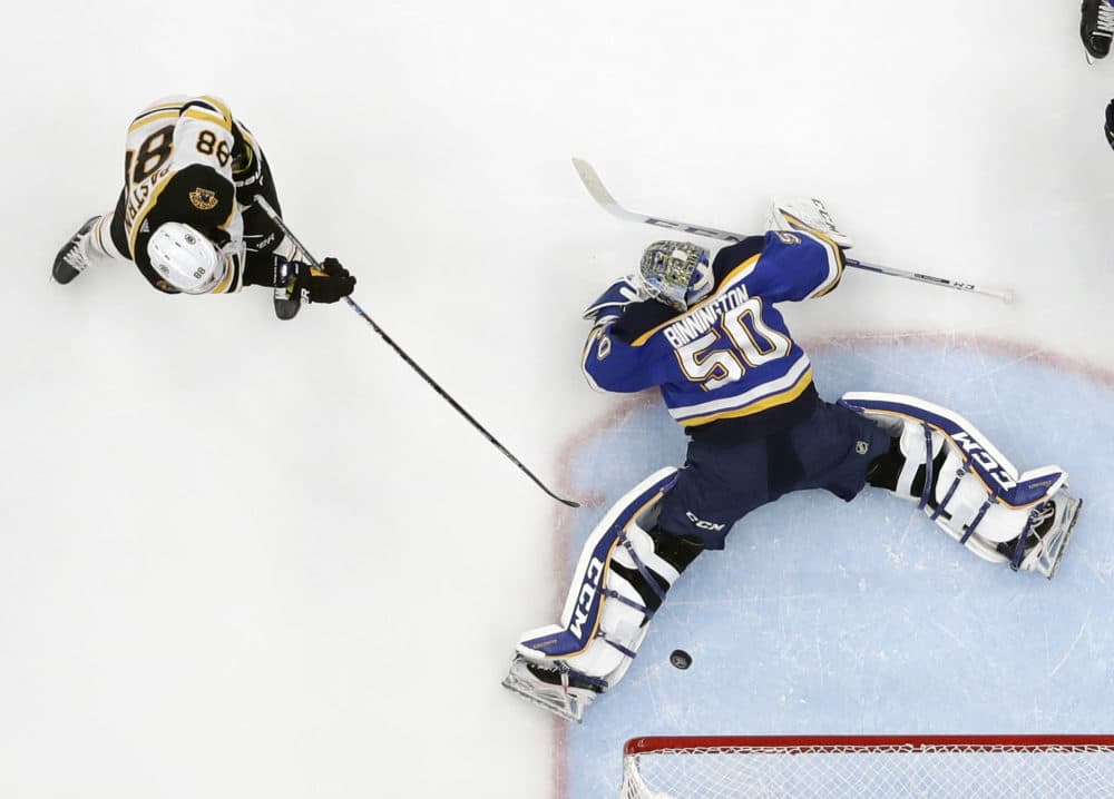 Boston Bruins right wing David Pastrnak (88), of the Czech Republic, scores a goal against St. Louis Blues goaltender Jordan Binnington (50) during the third period of Game 6 of the NHL hockey Stanley Cup Final Sunday in St. Louis. (Jeff Roberson/AP)