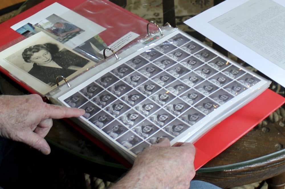 Ryan Cooper shows photos of Anne Frank that he kept in a scrapbook at his home in Yarmouth, Mass. The 48 small images were made in a photo booth in 1940. (Philip Marcelo/AP)