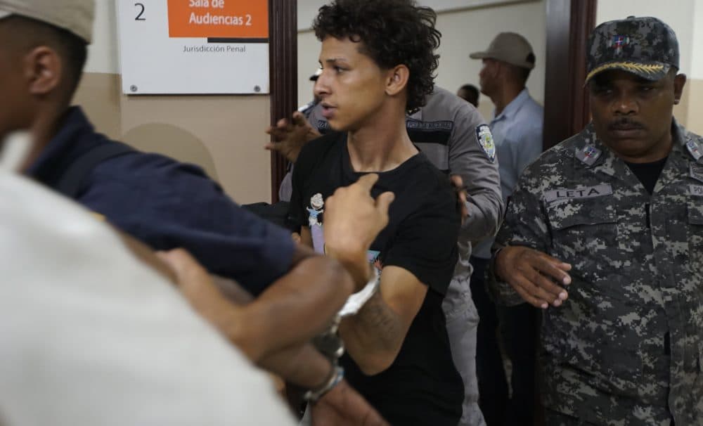 Rolfi Ferreira Cruz, 25, center, the alleged gunman, is taken to court by the police in Santo Domingo, Dominican Republic, on Thursday. (Roberto Guzman/AP)