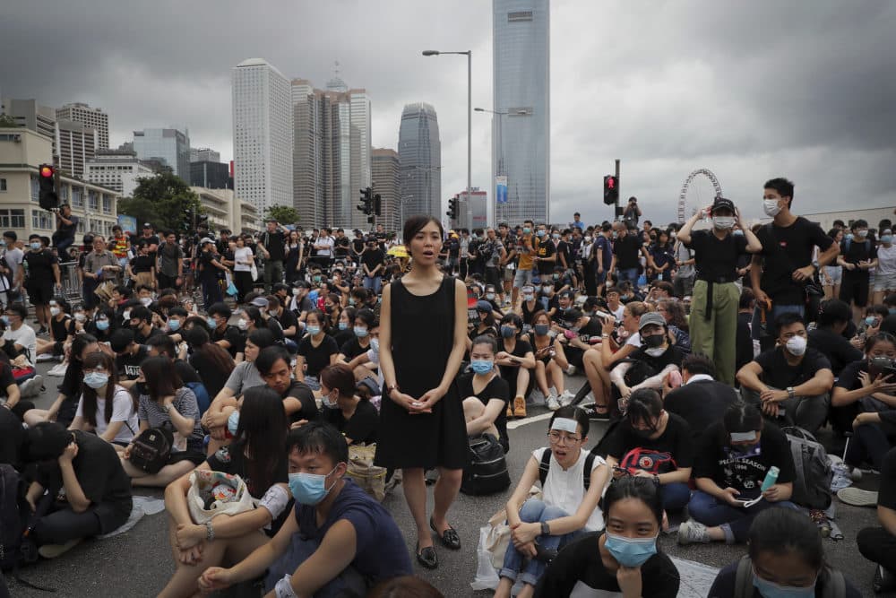 A protester, center, calls Hong Kong Chief Executive Carrie Lam to step down on Monday, June 17, 2019. (Kin Cheung/AP)