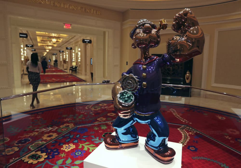 A woman walks past a giant Popeye sculpture by artist Jeff Koons displayed in a corridor at the Encore Boston Harbor casino. (Charles Krupa/AP)
