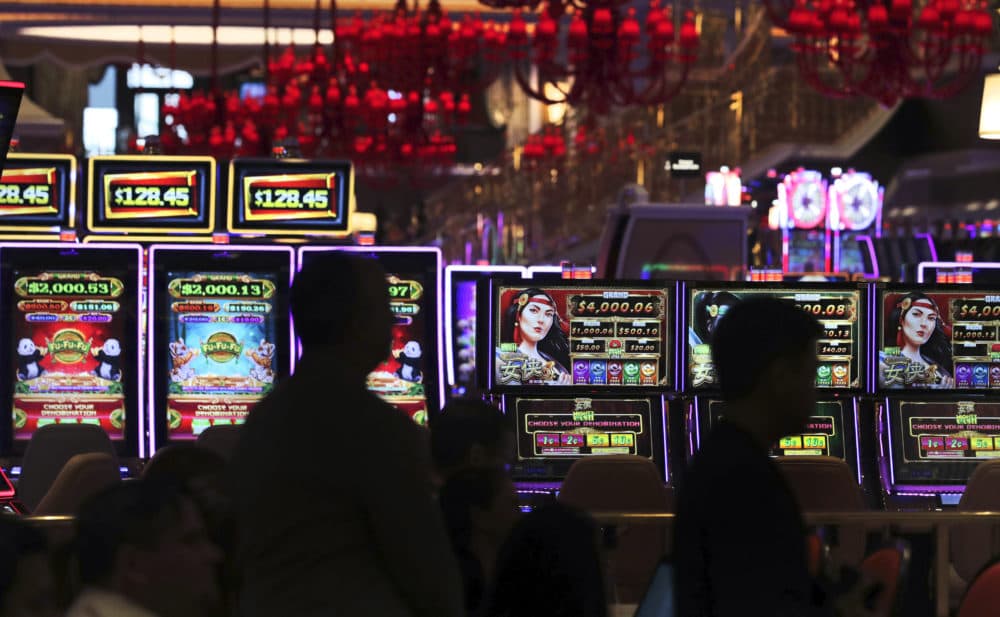 Casino workers listen during a news conference near the gaming floor at the Encore Boston Harbor casino on Friday. (Charles Krupa/AP)