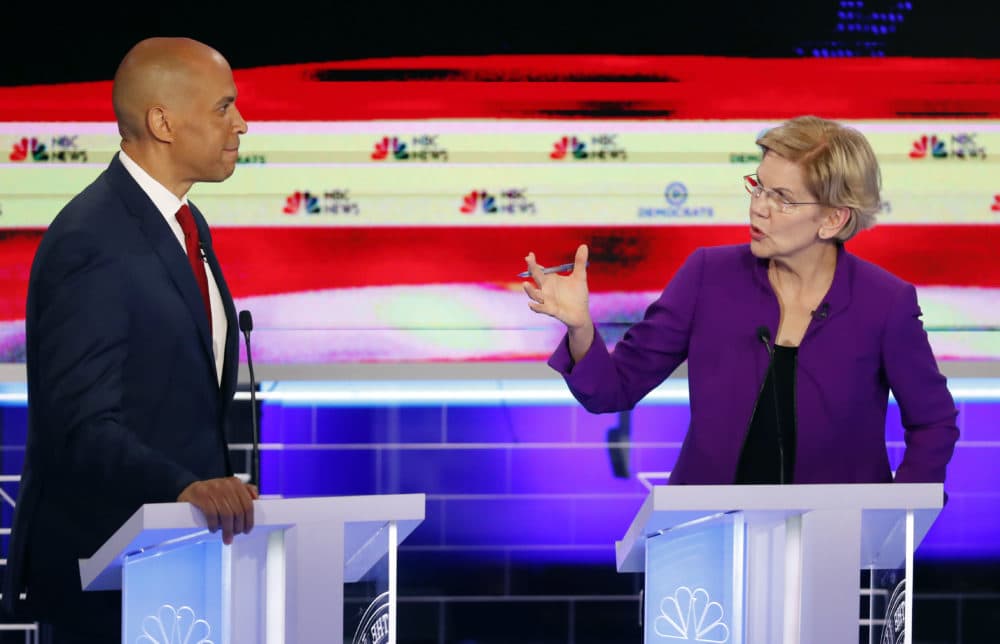 Democratic presidential candidate Sen. Elizabeth Warren, D-Mass., gestures towards New Jersey Sen. Cory Booker, during a Democratic primary debate on Wednesday, June 26, 2019, in Miami. (Wilfredo Lee/AP)