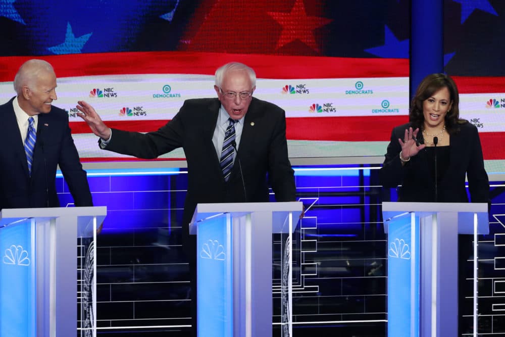 Democratic presidential candidate Sen. Bernie Sanders, I-Vt., , center, gestures towards former vice president Joe Biden, as Sen. Kamala Harris, D-Calif., talks, during the Democratic primary debate hosted by NBC News at the Adrienne Arsht Center for the Performing Art, Thursday, June 27, 2019, in Miami. (Wilfredo Lee/AP)