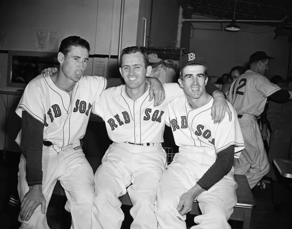In this 1949 file photo, Red Sox pitcher Mel Parnell, center, is flanked by teammates Ted Williams, left, and Johnny Pesky after defeating the New York Yankees 4-1 in a game at Fenway Park. (AP)