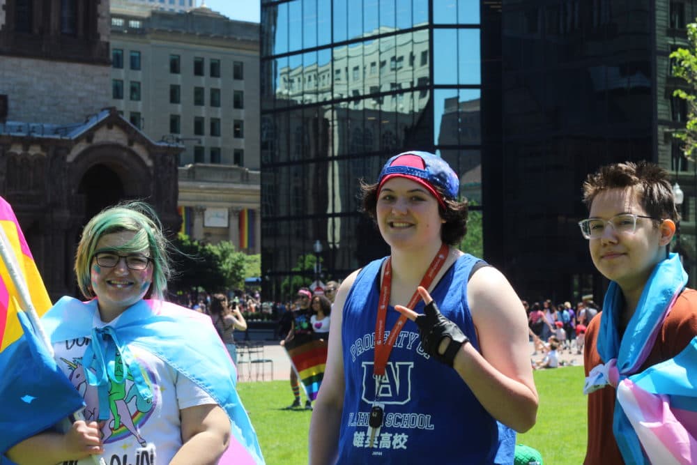 Ian Ruoff (center) with friends Elias Sterling (left) and Mars Drake (right) at Boston's 49th annual Pride Parade celebration. (Quincy Walters/WBUR)