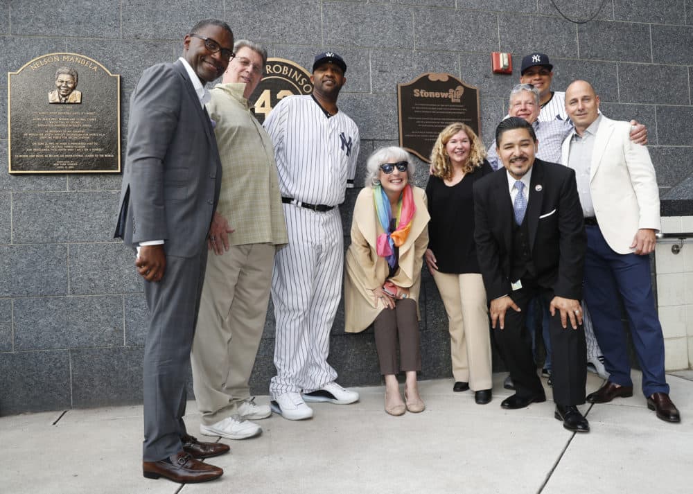 Representatives of the the Stonewall Inn and the New York Yankees, including pitcher CC Sabathia, third from left; relief pitcher Dellin Betances, second from right; and Stonewall co-owner Kurt Kelly, third from right; honor the 50th anniversary of the Stonewall uprising after the Yankees unveiled a plaque in Monument Park Tuesday, June 25, 2019, in New York City. (Kathy Willens/AP)