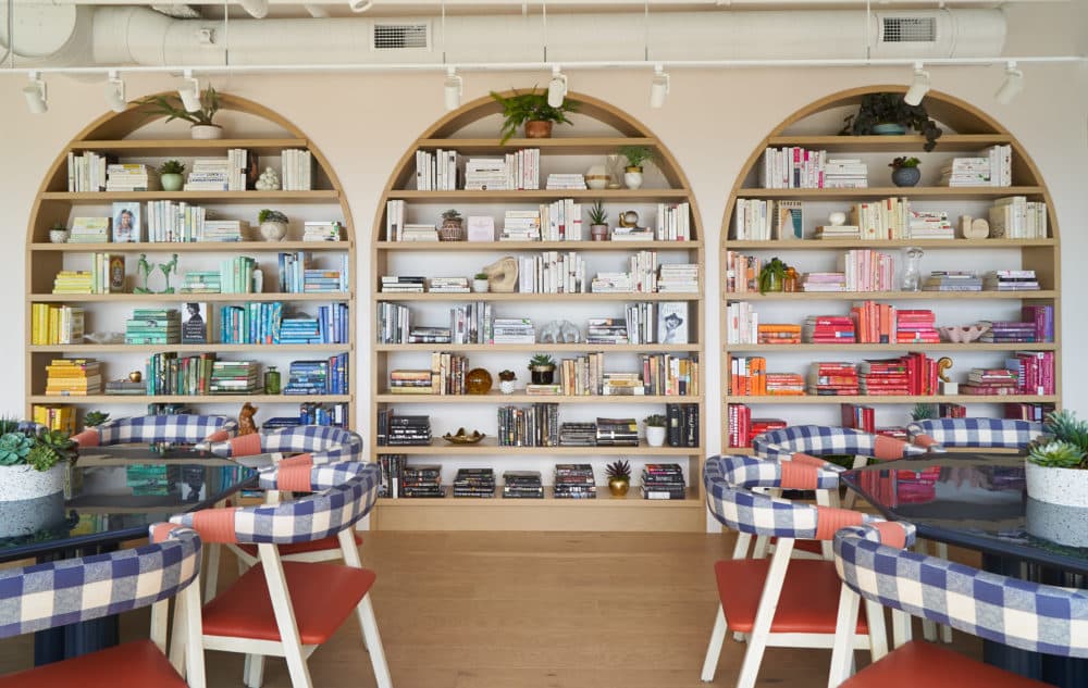 A bookshelf is shown at The Wing's Boston location. The coworking company says it stocks its library with books written by women. (Courtesy Tory Williams/The Wing)