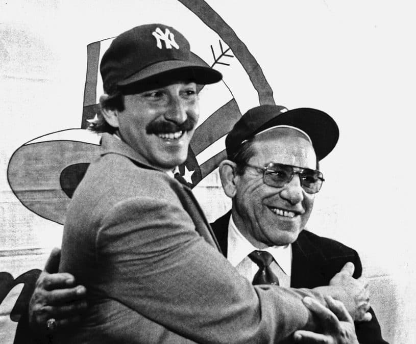 Dale Berra poses with his father at Yankee Stadium after being traded to New York. (Paul Burnett/AP)