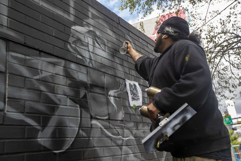 Genaro Ortega, who goes by Go Five, works on his piece depicting an elder. (Jesse Costa/WBUR)