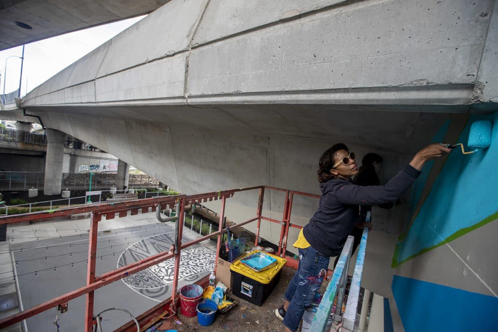 Silvia López Chavez adds in bold blue layers to her piece. (Jesse Costa/WBUR)